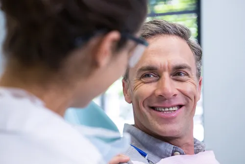 patient smiling during dental consultation for tooth sensitivity