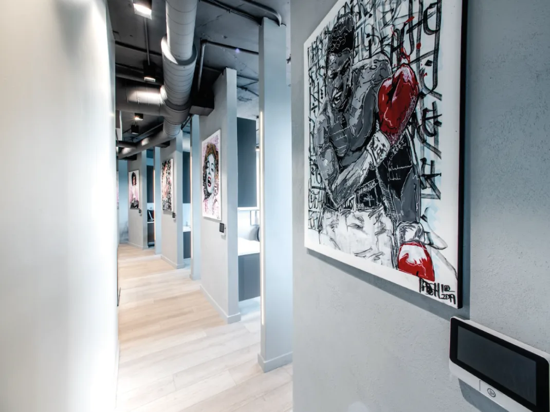 Hallway in a dental office featuring contemporary art, modern decor, and ambient lighting.