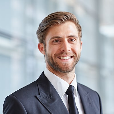 Young business man wearing a suit and smiling