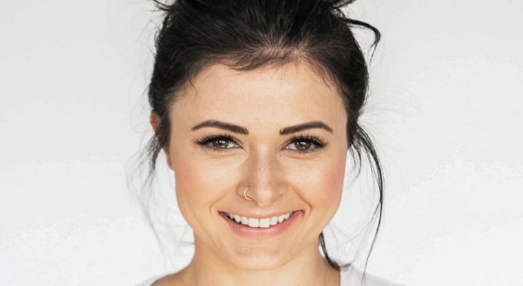 Myth Busting with Smiles on The Hudson Female with dark hair tied in a bun smiles