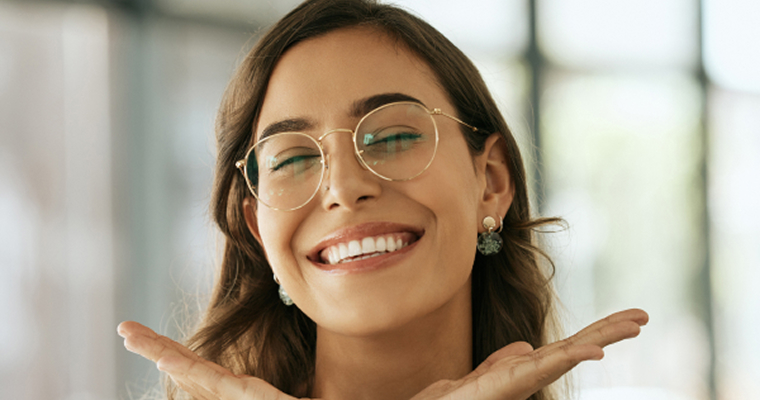 Woman in glasses smiling happily